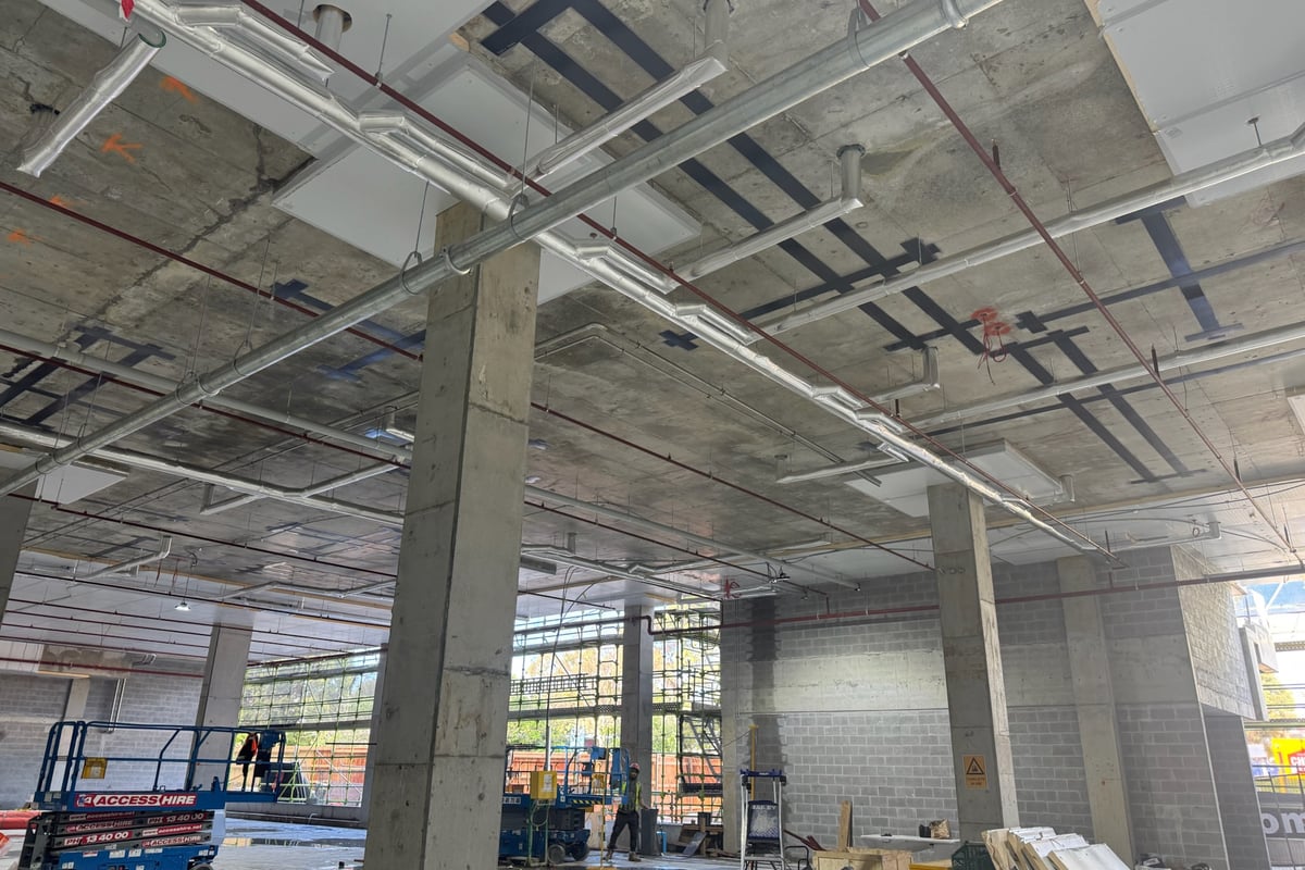 CFRP wrap installation in progress on pavilion support beam