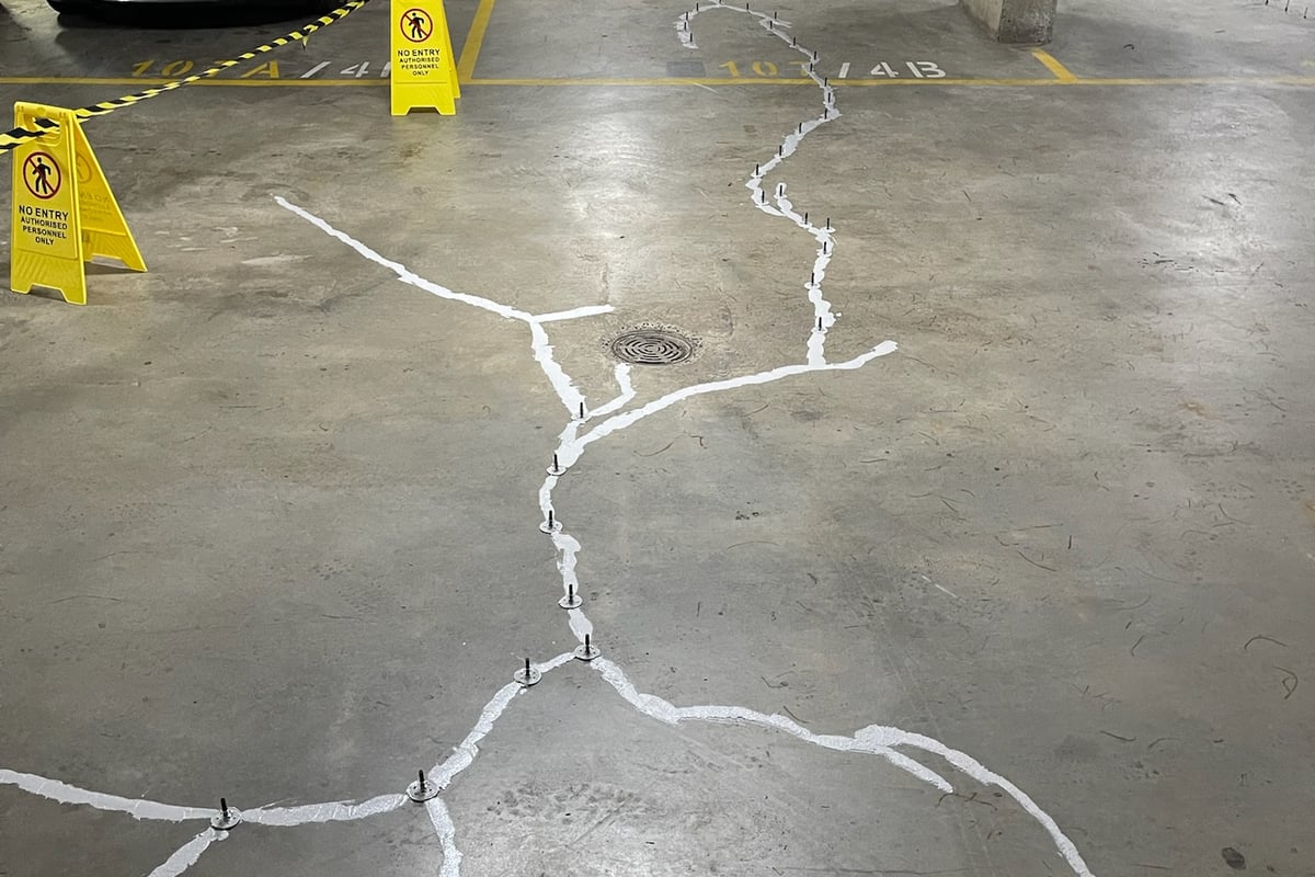Flexible epoxy crack injection using pressure-monitored equipment